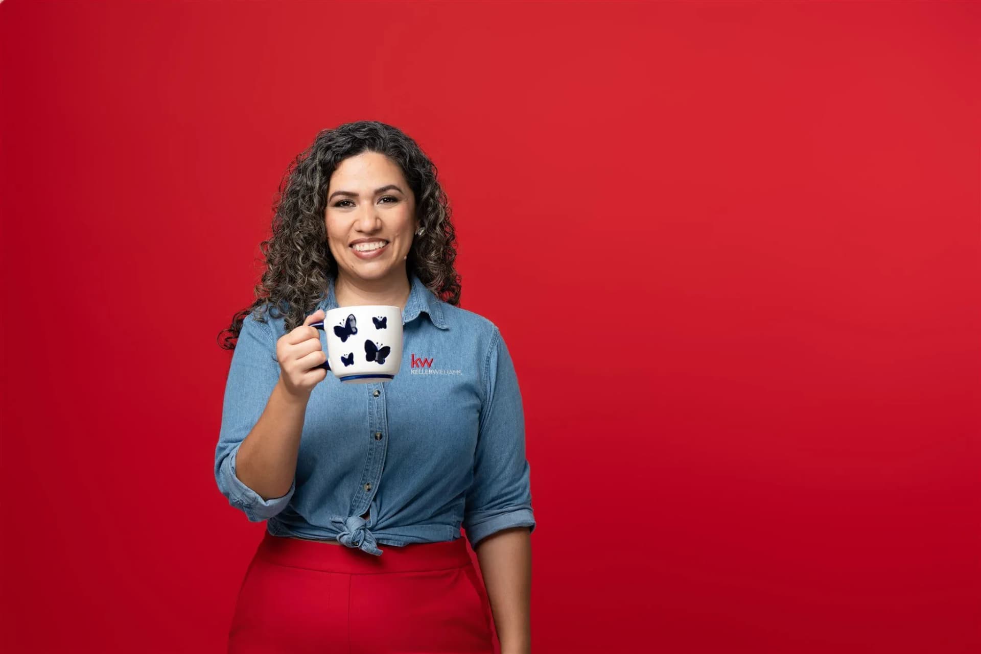 Founder portrait against a red studio background