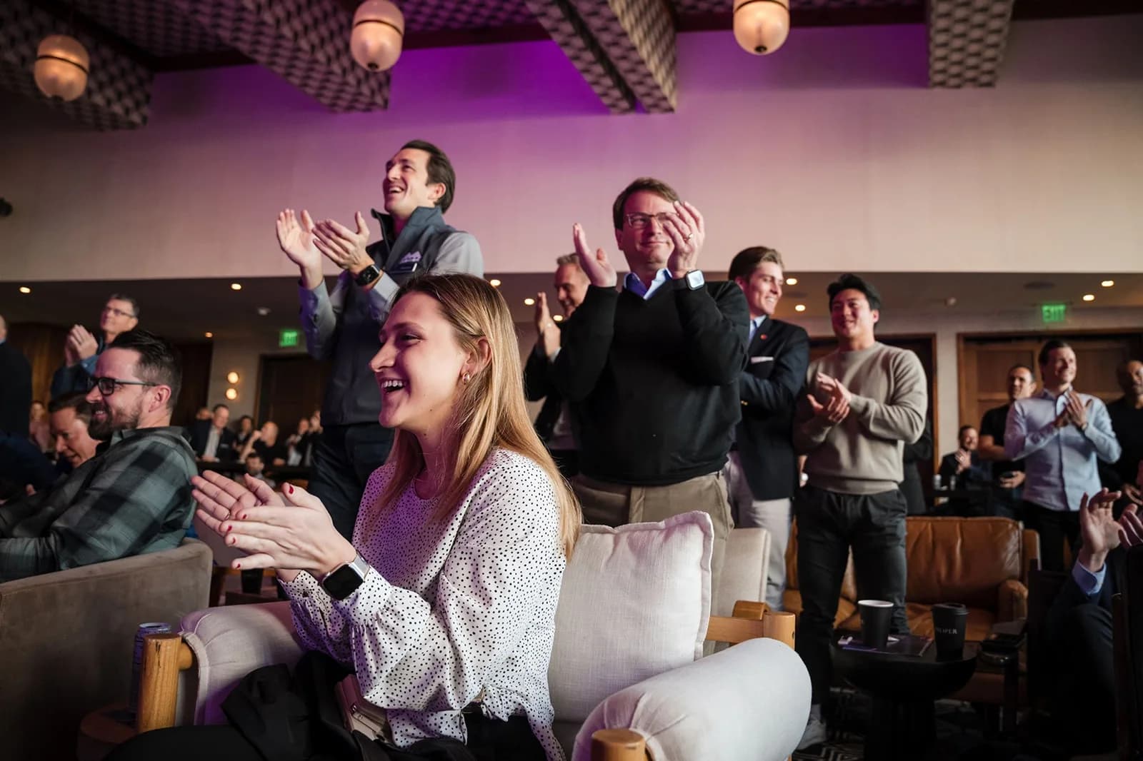 Conference audience applauding during a presentation